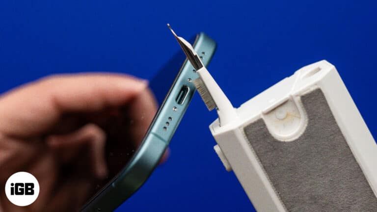 Cleaning an iPhone's charging port.